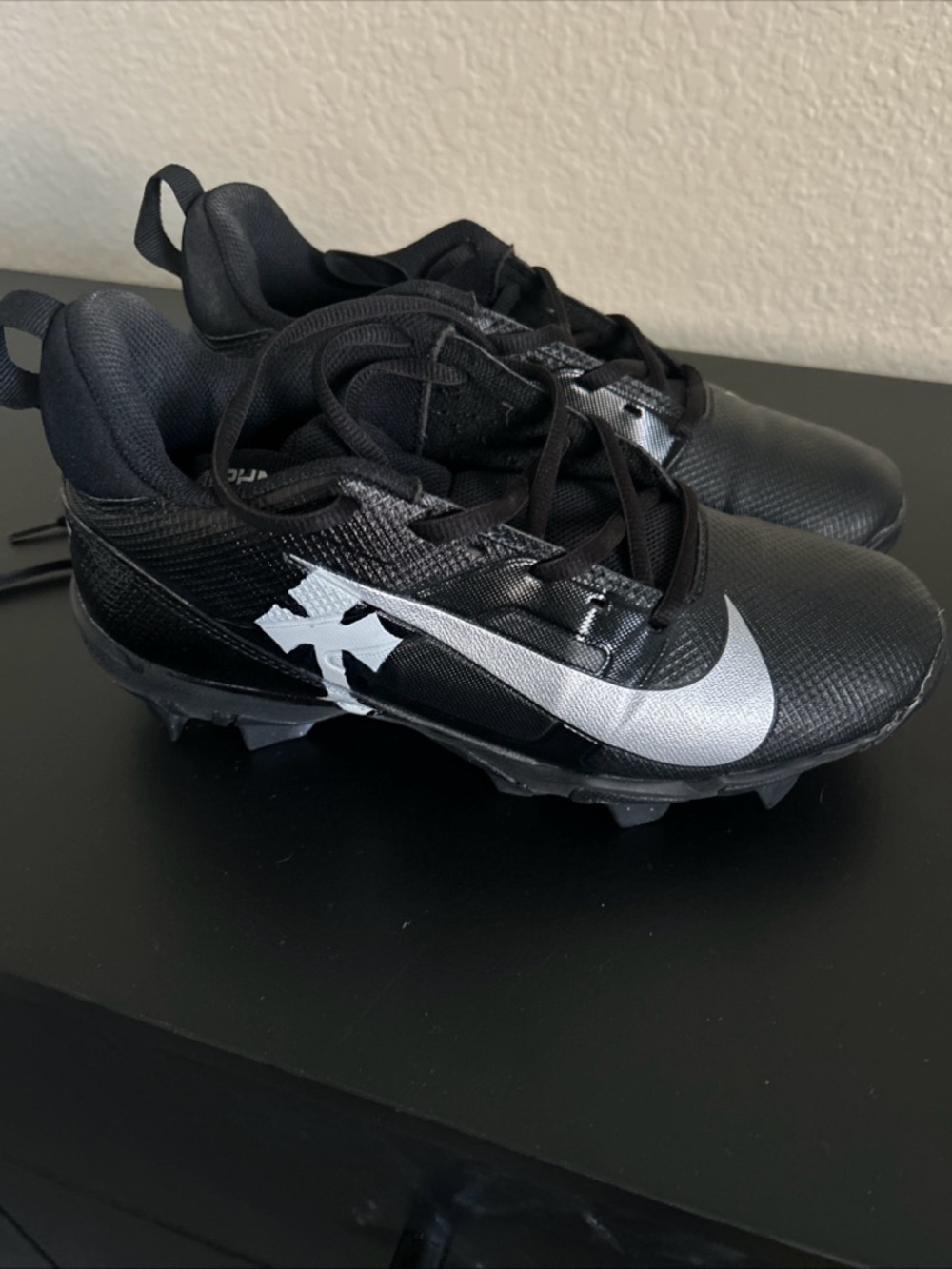 Nike Black Cleats with Silver Swoosh Accent